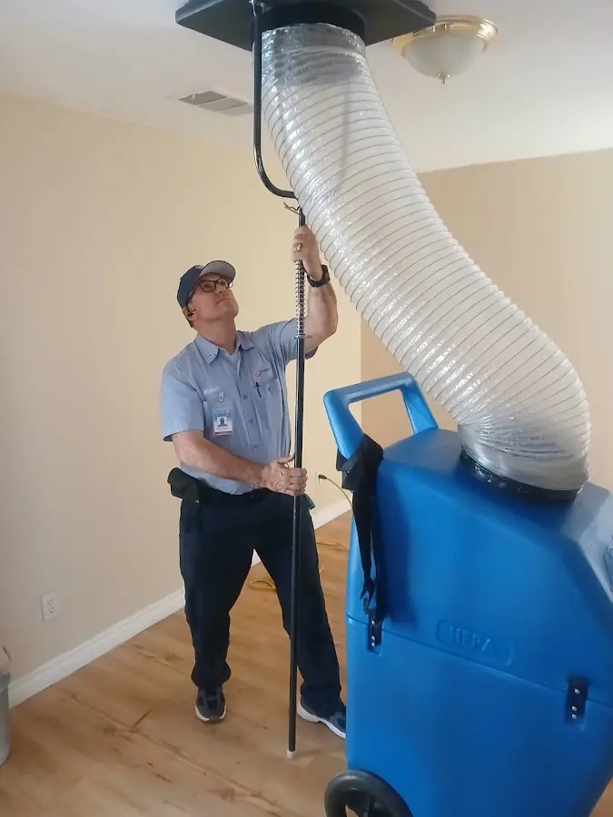 Furnace Tune-Up technician using HEPA equipment in Webster